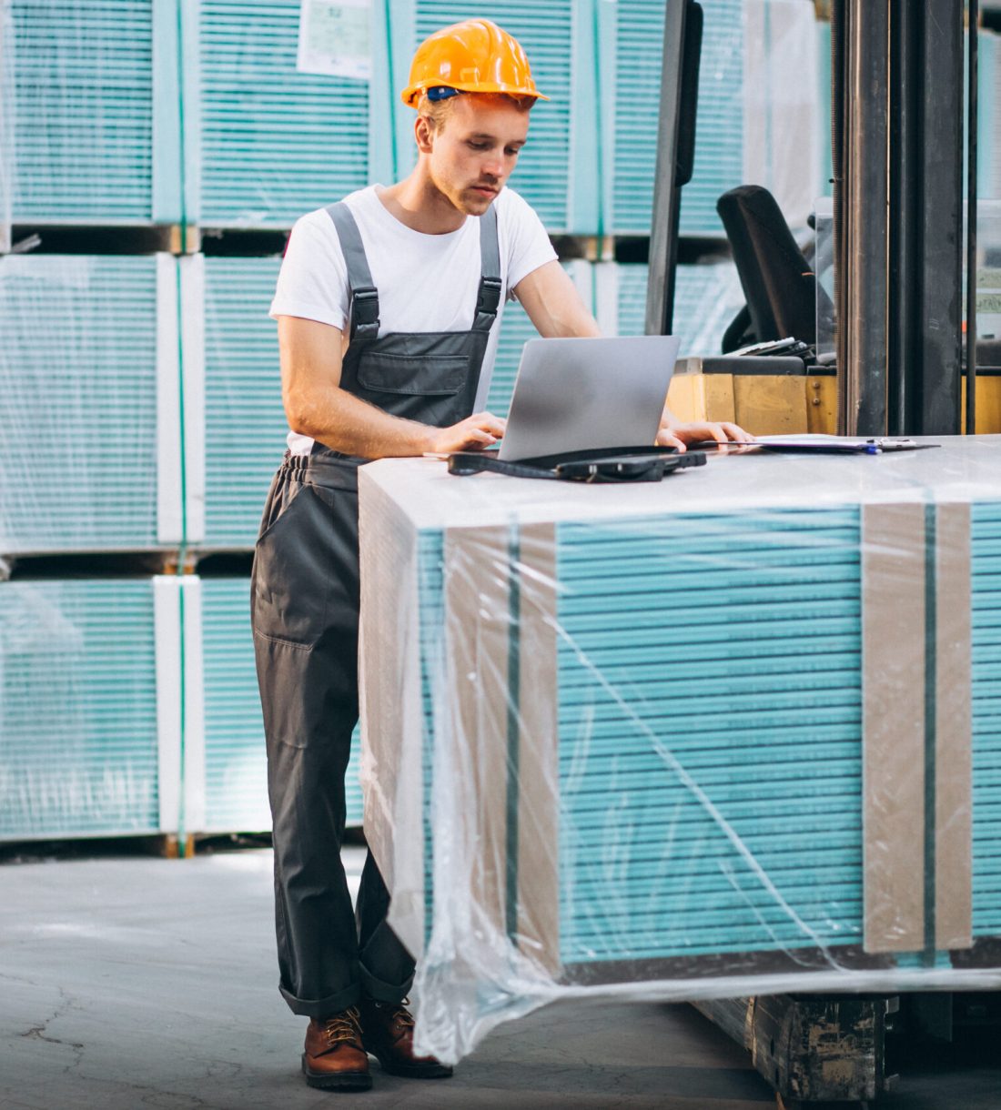 Young man working at a warehouse with boxes